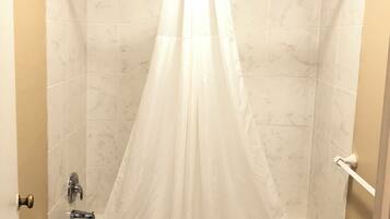 Room, 1 King Bed, Non Smoking | Bathroom | Combined shower/tub, free toiletries, towels