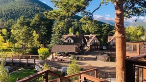 A traditional wooden building with a thatched roof, surrounded by a small pond and a wooden deck. - The Landing at Estes Park - Riverside Retreat (Estes Park)