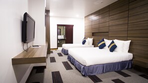 A hotel room with two beds, a TV, a wooden headboard, and a bathroom visible through an open door. - Family Boutique Hotel (Vientiane)