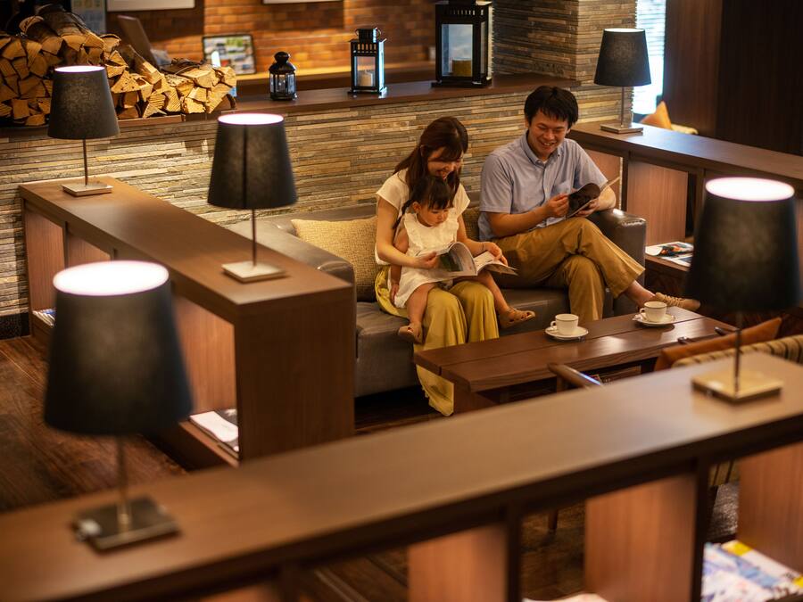 A cozy lounge area with seating, tables, and lamps.