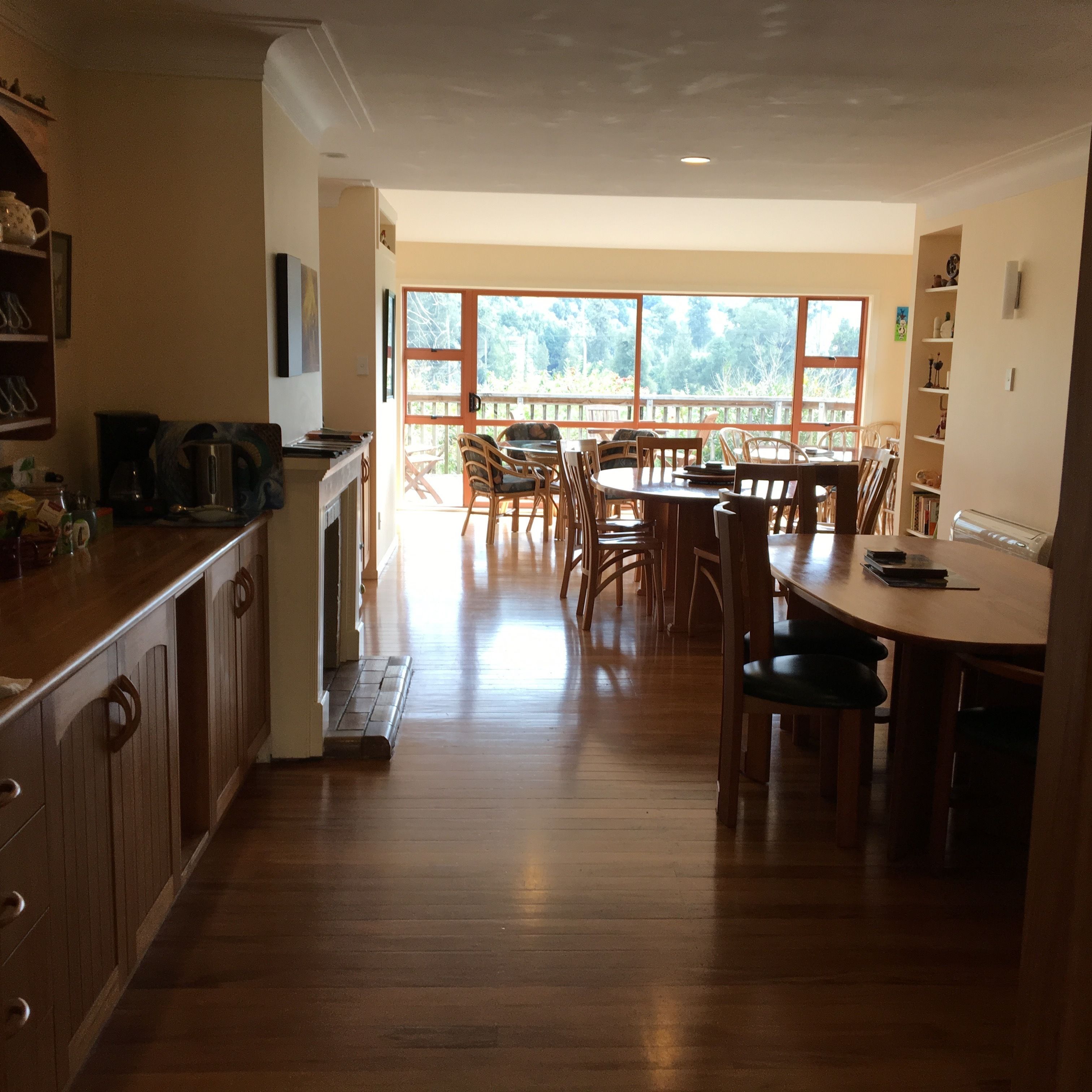 A spacious kitchen with wooden cabinets and a dining area with a large table and chairs.