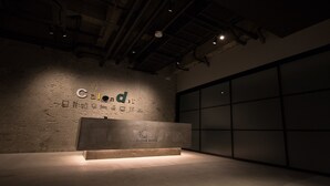 A reception desk with a sign reading "Calendar Hotel" and a large window to the right.