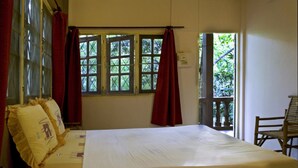A room with a bed, a chair, and a window with curtains. - Lost Resort (Rayong)