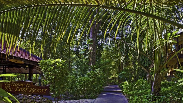 A pathway leading to a building with a sign reading "Welcome to The Lost Resort." - Lost Resort (Rayong)