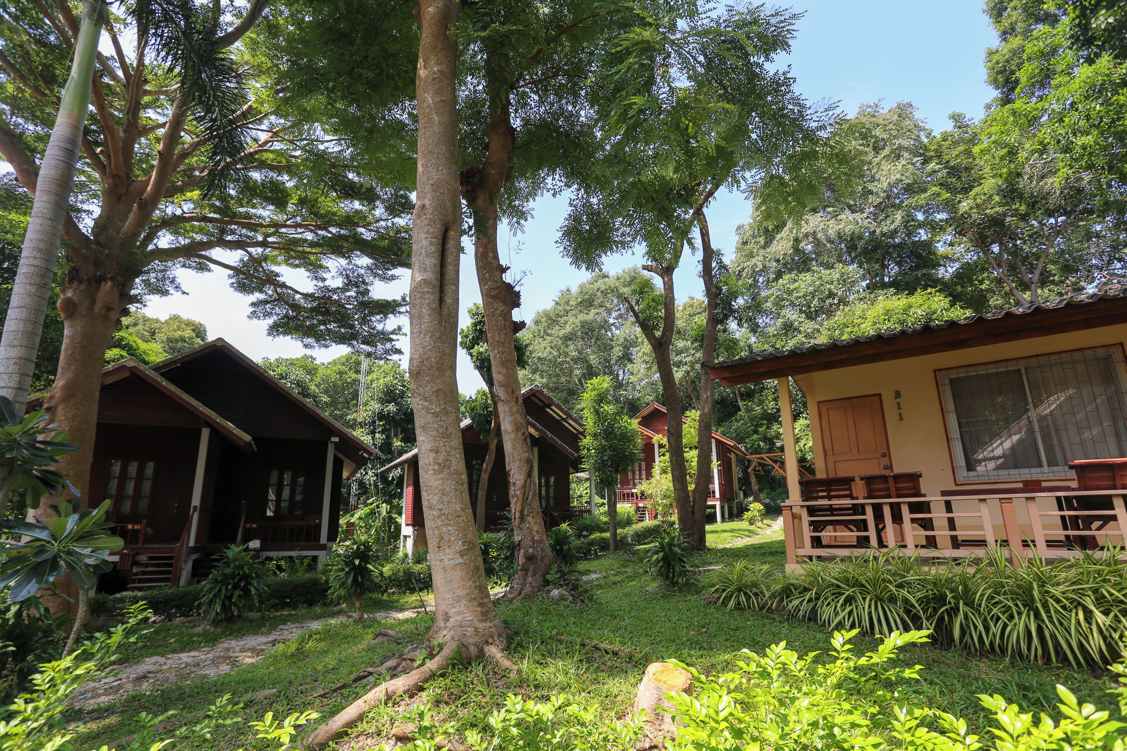 A bungalow-style accommodation with a porch and a small garden area.