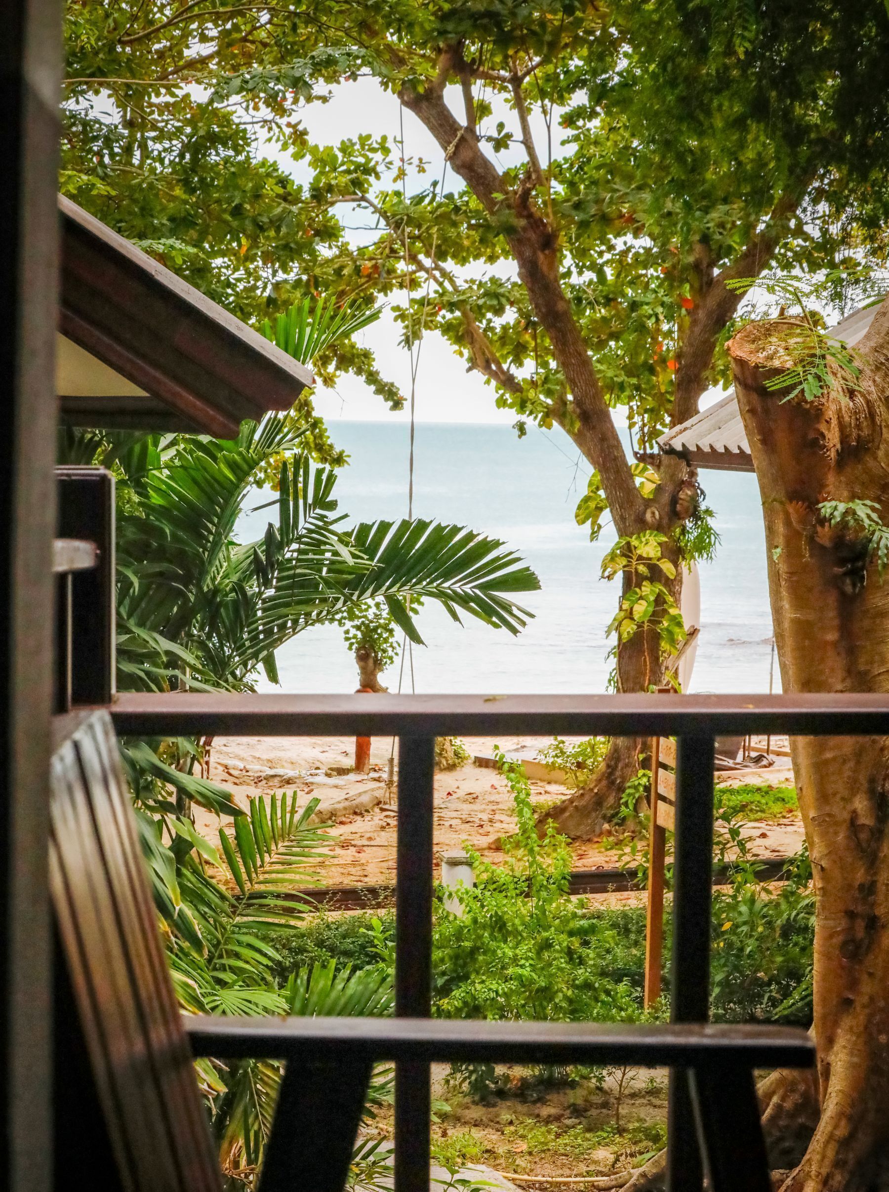 A balcony with a view of the beach and ocean.