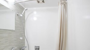 A compact bathroom with a toilet, sink, and shower area. - Nagasaki IK Hotel (Nagasaki)