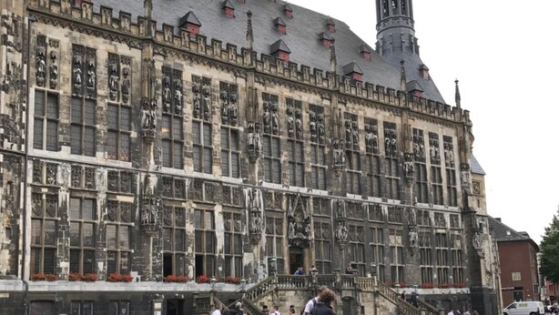 A historic building with a prominent tower and detailed facade. - Gasterij Berg & Dal (Slenaken)