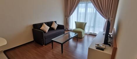 A modern living room with a sofa, armchair, and coffee table.