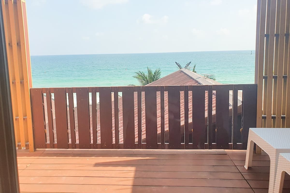 A wooden deck with a view of the ocean.