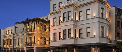 A multi-story hotel with a classic architectural style, featuring a prominent entrance with a marquee sign.
