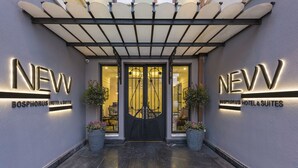 The entrance to Bosphorus Hotel & Suites with a modern design, featuring a black double door and illuminated signage. - New Bosphorus Hotel (Istanbul)