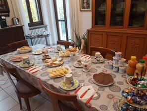 A dining table set with various dishes, utensils, and condiments. - B&B La Crota (Asti)