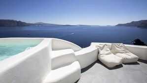 A white infinity pool with a clear view of the sea and distant islands. - Ducato di Oia - Adults Only (Santorini)