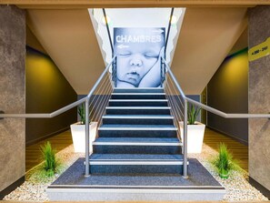 A staircase with a sign reading 'CHAMBRES' leading to an upper level.
