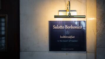 A sign for Salotto Borbonico bed & breakfast in the heart of Naples.