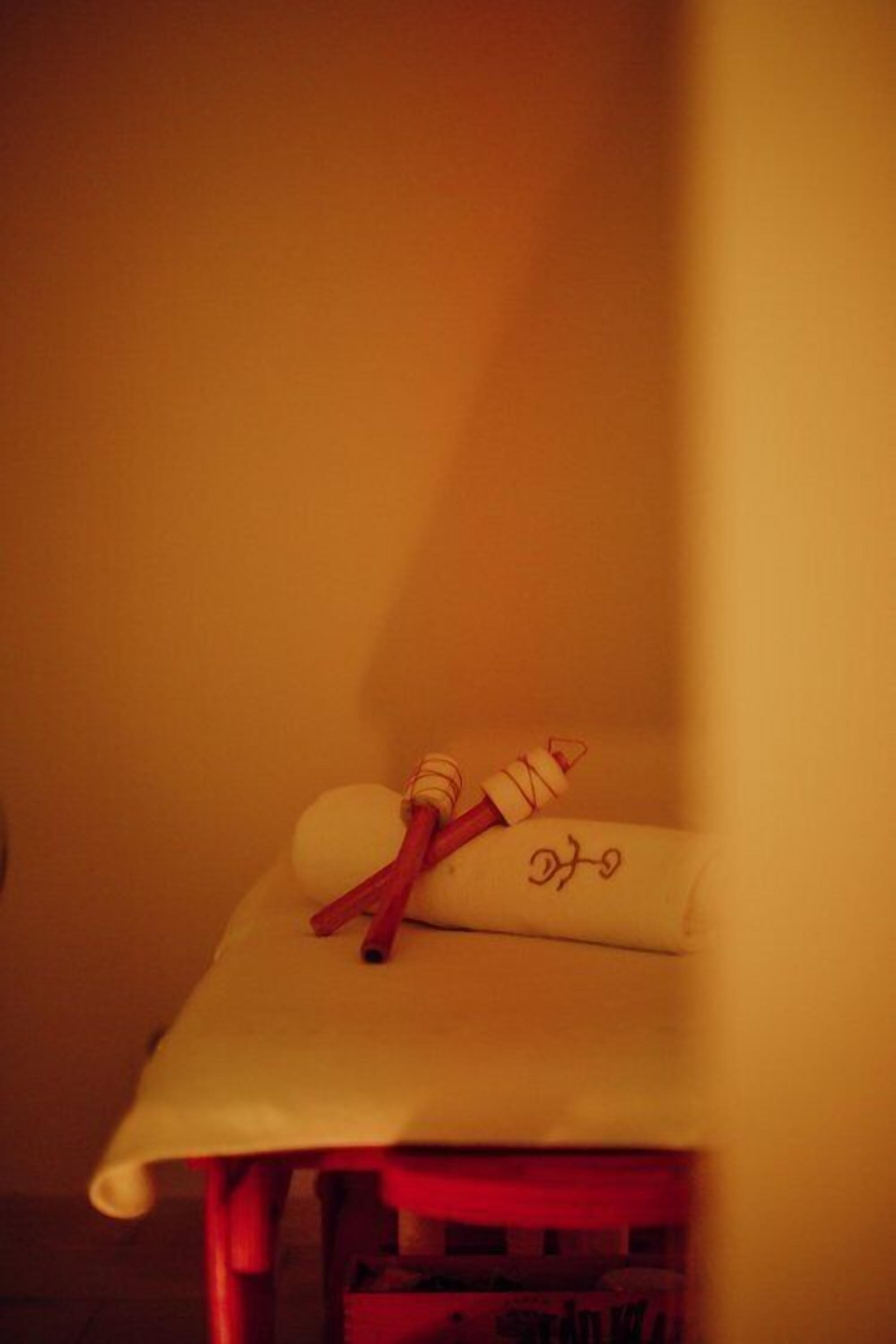 A small, cozy room with a single bed and a nightstand.