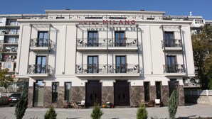 A hotel building with balconies, a central entrance, and a sign reading "HOTEL MILANO". - Hotel Milano (Burgas)