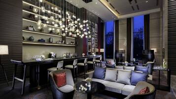 A modern interior with a bar area, seating, and a large window.