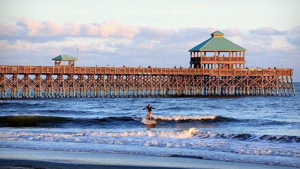 A wooden pier extending into the sea with a covered structure at the end. - Turtle Bay 10 3 Bedroom Holiday Home By My Ocean Rentals (Folly Beach)