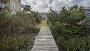 A wooden pathway leading to a building with a balcony. - E Ashley 1634 4 Bedroom Holiday Home By My Ocean Rentals (Folly Beach)