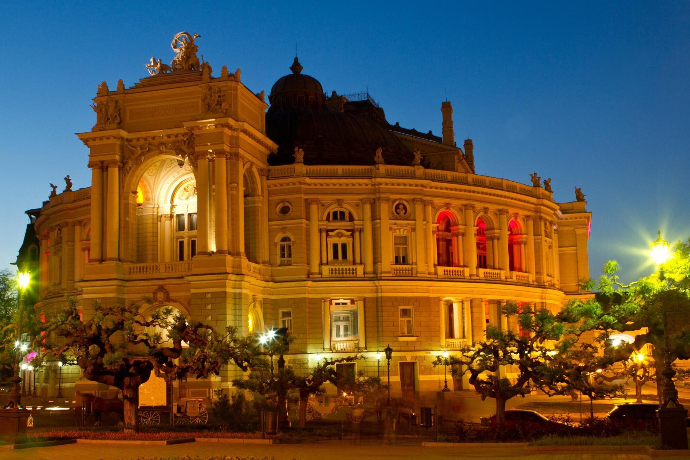 A grand, historic building with classical architecture, featuring a prominent dome and ornate decorations.