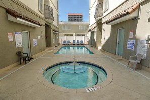 A pool area with two pools, lounge chairs, and safety signs. - Tuscan Ocean Vista C Holiday Home 8 bedroom By Affordable Large Properties (Myrtle Beach)