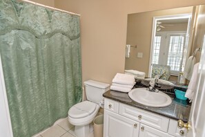 A bathroom with a toilet, sink, and mirror. - Bermuda Breeze D Holiday Home 8 bedroom By Affordable Large Properties (North Myrtle Beach)