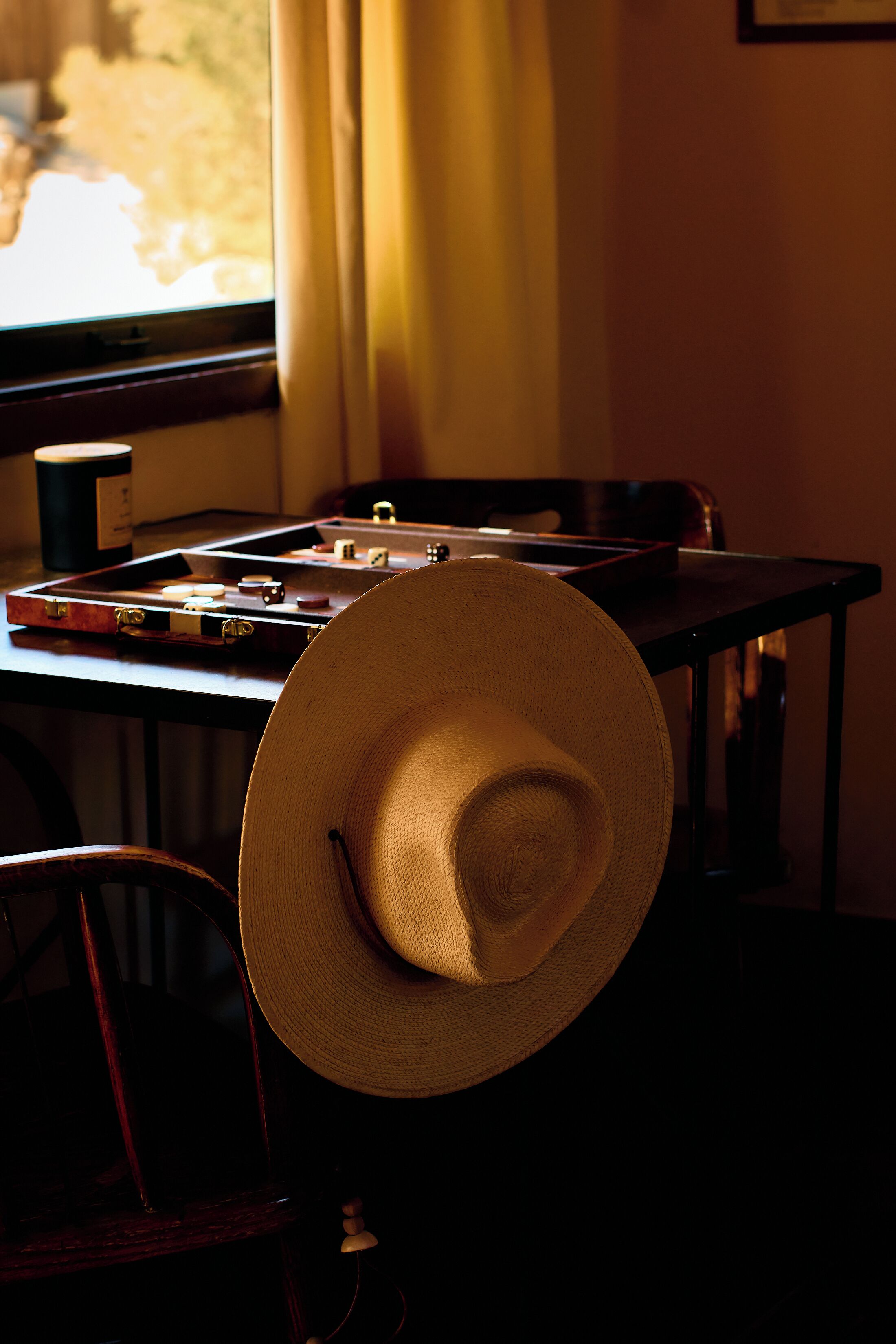 A hat on a table with a window in the background.