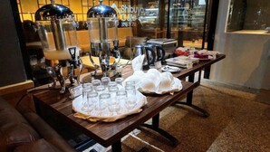 Une table avec du matériel pour préparer le café et un plateau de verres, probablement pour servir le café.