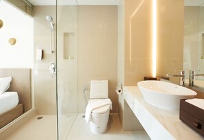 A modern bathroom with a glass shower enclosure, a white toilet, a large sink, and a mirror. - Centara Life Phu Pano Krabi (Krabi)