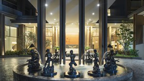 A modern building with a central courtyard featuring a water fountain with statues. - Centara Life Phu Pano Krabi (Krabi)