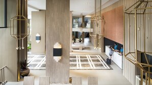 A spacious lobby with a central column, seating area, and a reception desk. - Centara Life Phu Pano Krabi (Krabi)