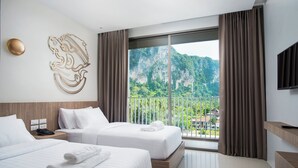 A hotel room with two beds, a large window with a view of mountains, a flat-screen TV, and a wall-mounted artwork. - Centara Life Phu Pano Krabi (Krabi)