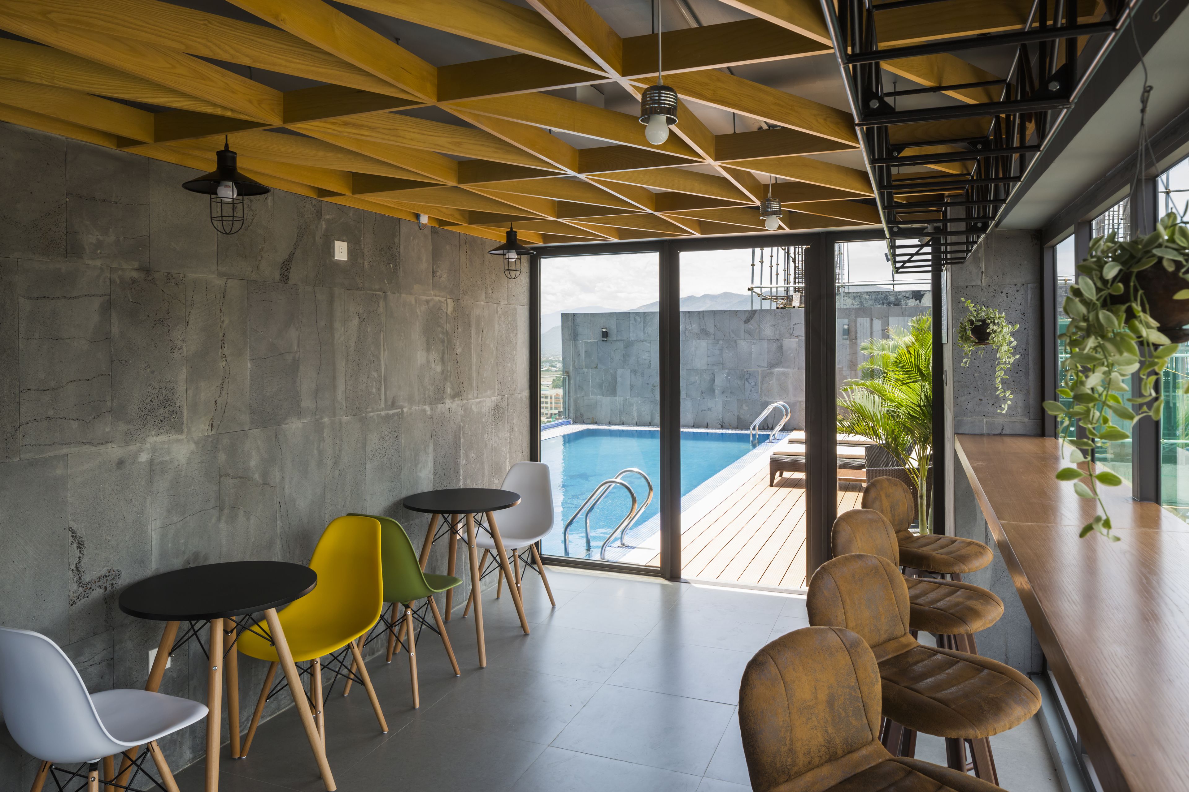 A modern interior with a pool, seating area, and large windows.