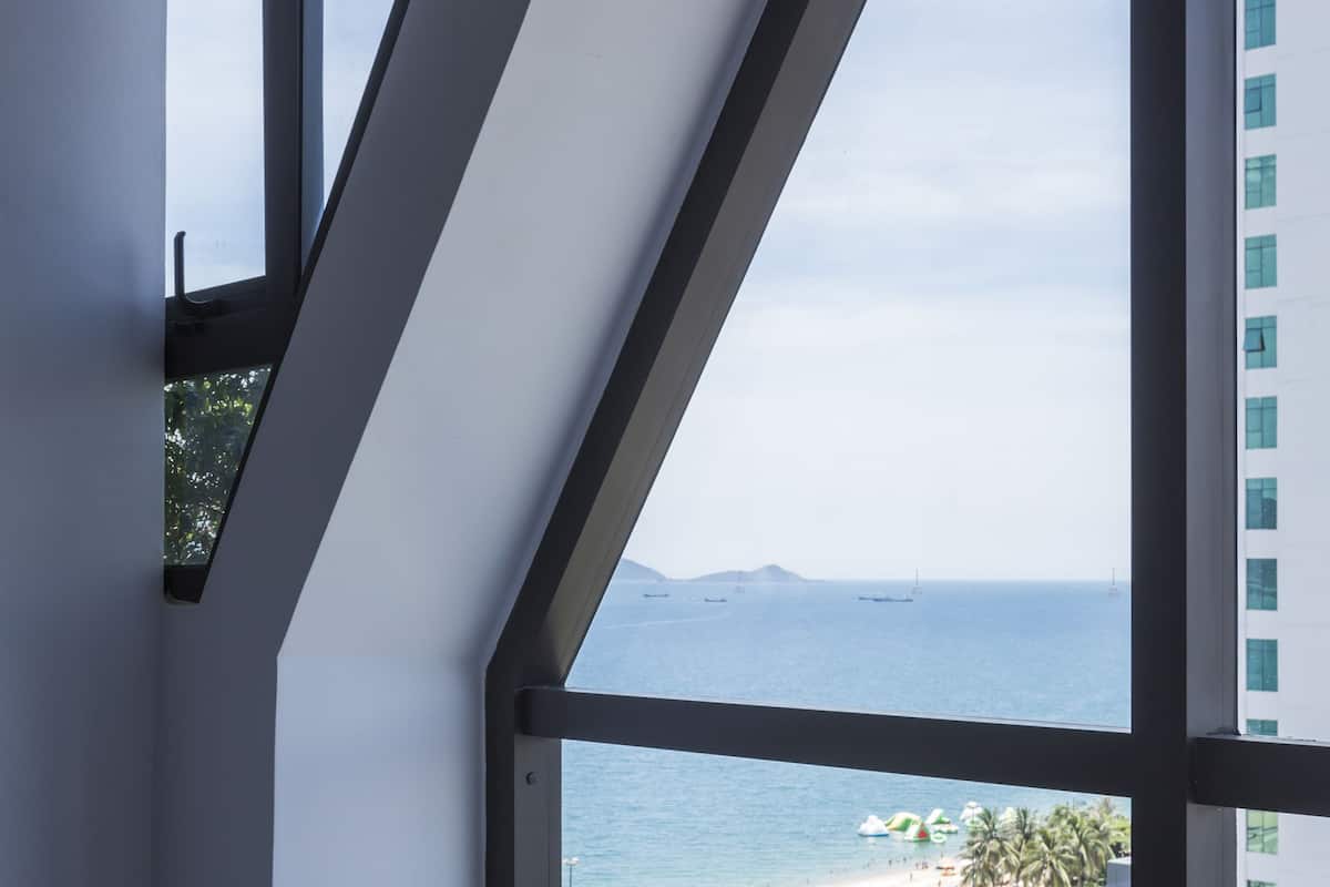 deluxe triple room, partial ocean view | 1 bedroom, premium bedding, minibar, in-room safe