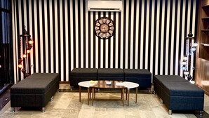 A modern living room with a sofa set, a coffee table, and a decorative clock. - Express Inci Airport Hotel (Istanbul)