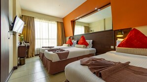 A hotel room with two beds, a TV, a mirror, and a window with curtains. - Hotel Rio (Nairobi)