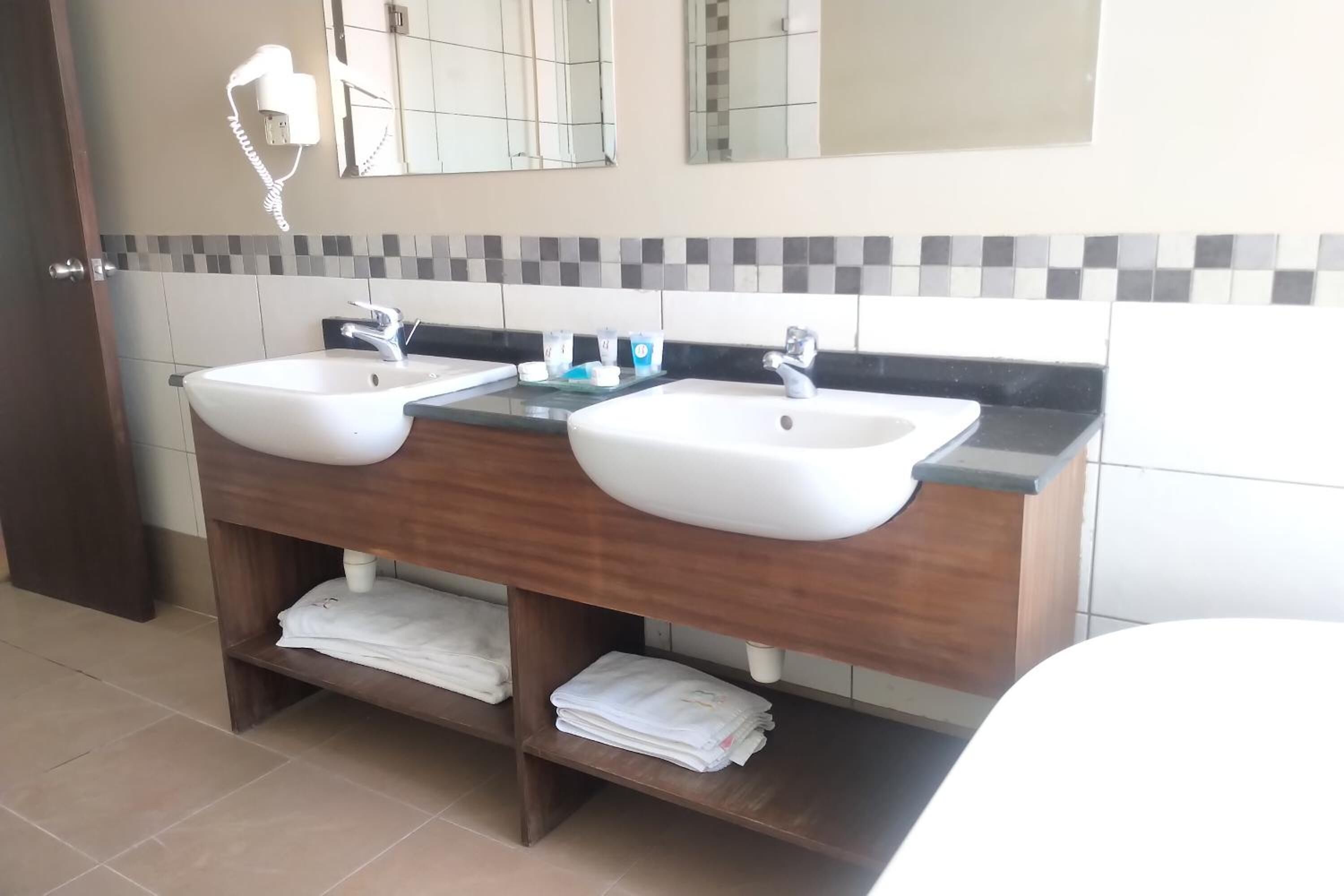 deluxe room | bathroom | shower, free toiletries, hair dryer, slippers