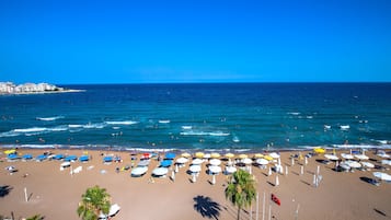 On the beach, sun loungers, beach umbrellas