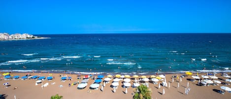 On the beach, sun loungers, beach umbrellas