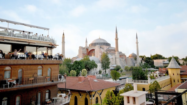 A view of a historic building with multiple minarets and domes, surrounded by trees and other buildings. - Side Hotel (Istanbul)