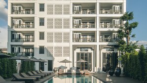 A multi-story hotel with a swimming pool in the foreground. - Buri Siri Hotel (Chiang Mai)