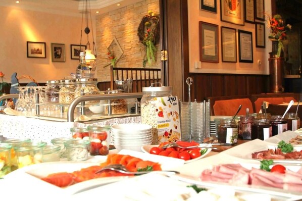 A buffet setup with various food items and condiments.