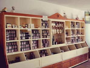 A large display case with multiple shelves containing various products. - Hotel Restaurant Gemmer (Rettert)