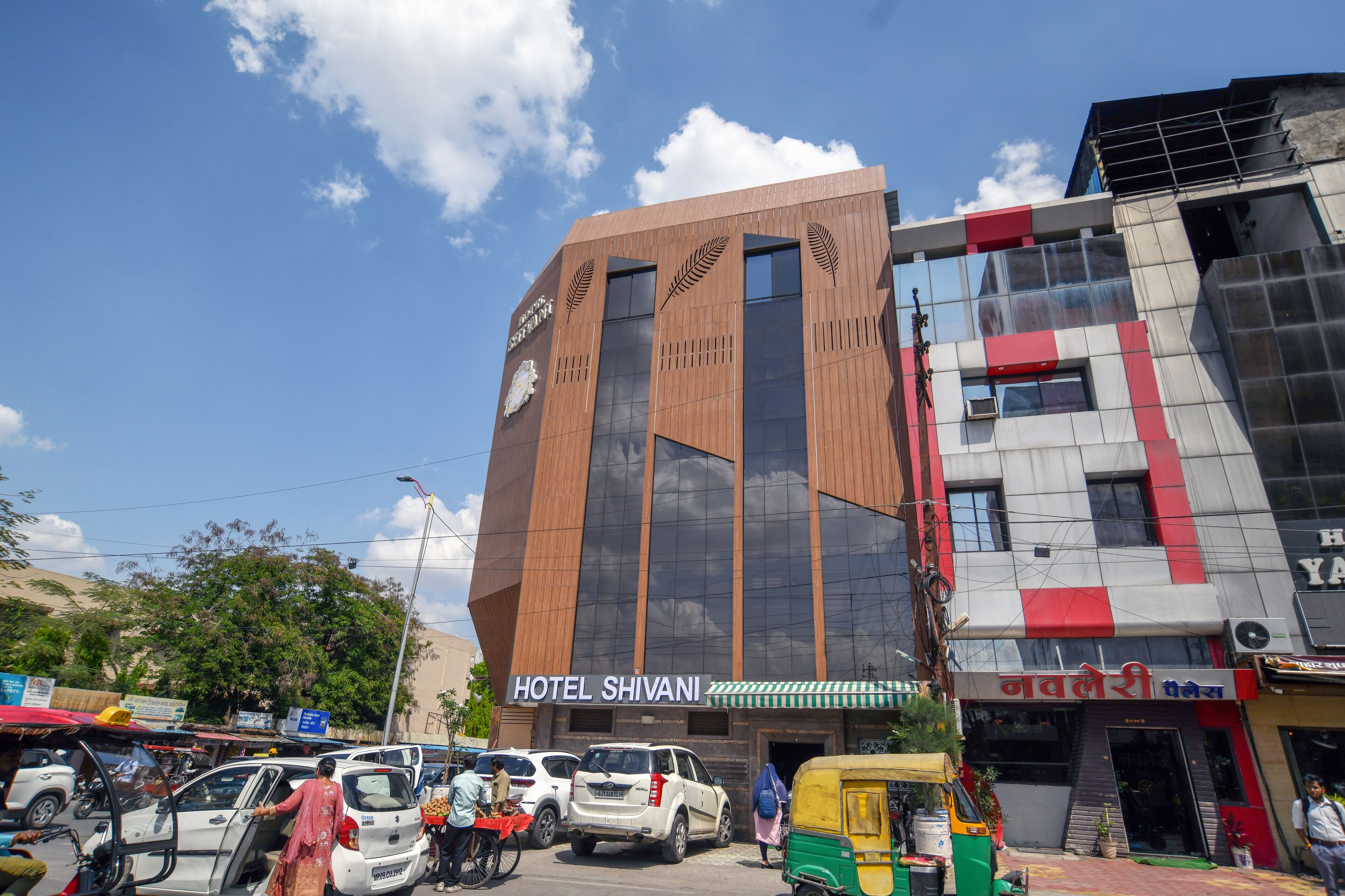 A modern building with a sign for Hotel Shivani.