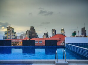 A swimming pool with a city skyline in the background. - C-View Boutique (Pattaya)