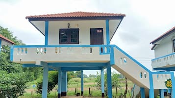 A two-story building with a blue and white color scheme, a covered porch, and a door marked "K4".