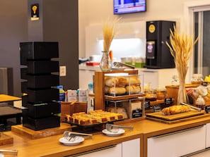 Enjoy a delicious breakfast spread with a variety of bread, pastries, and beverages.