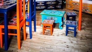 Interno di una yurt tradizionale con una struttura centrale a volta, mobili colorati e una parete a griglia in legno.